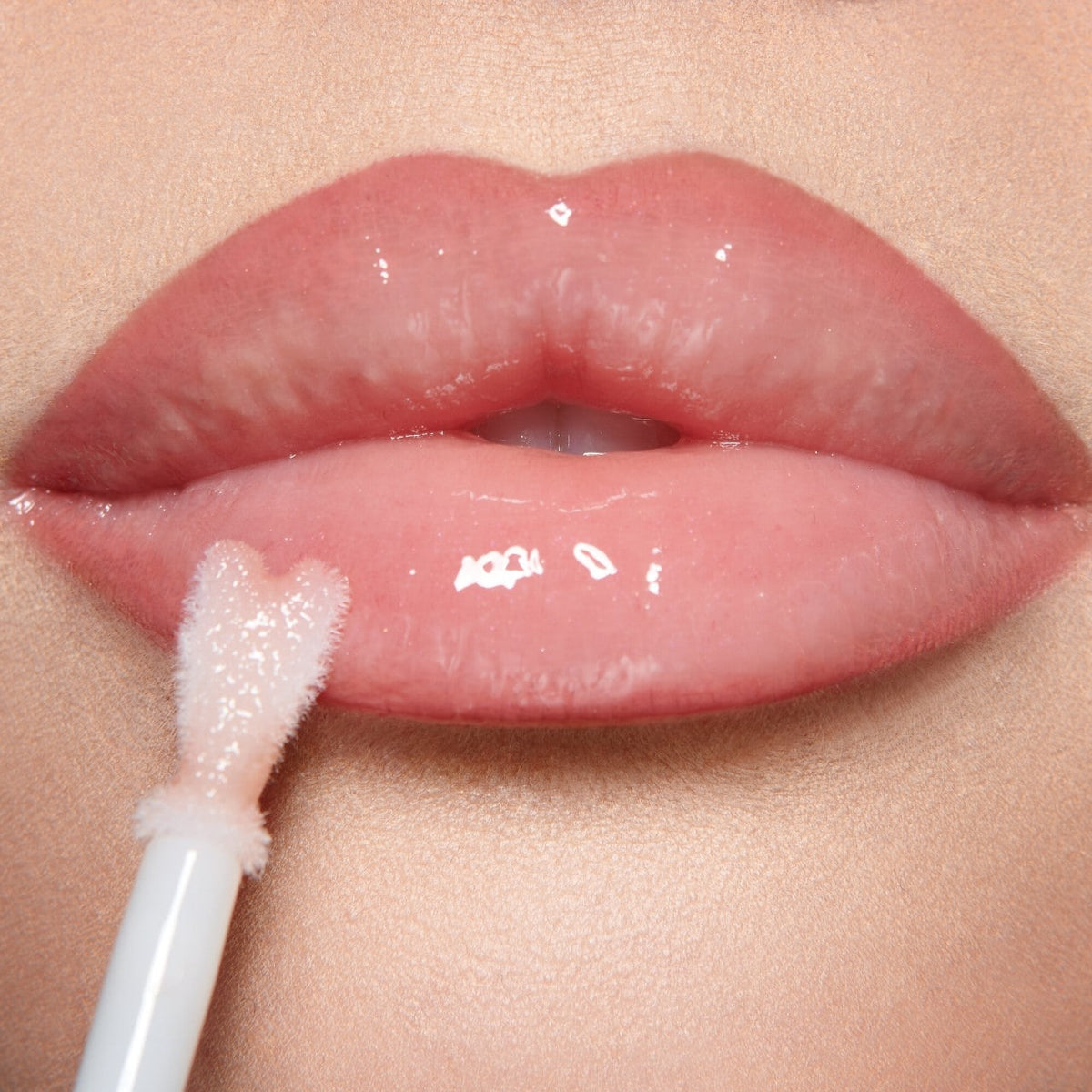 Glossy fresh pink lips with Collagen Lip Bath heart-shaped applicator