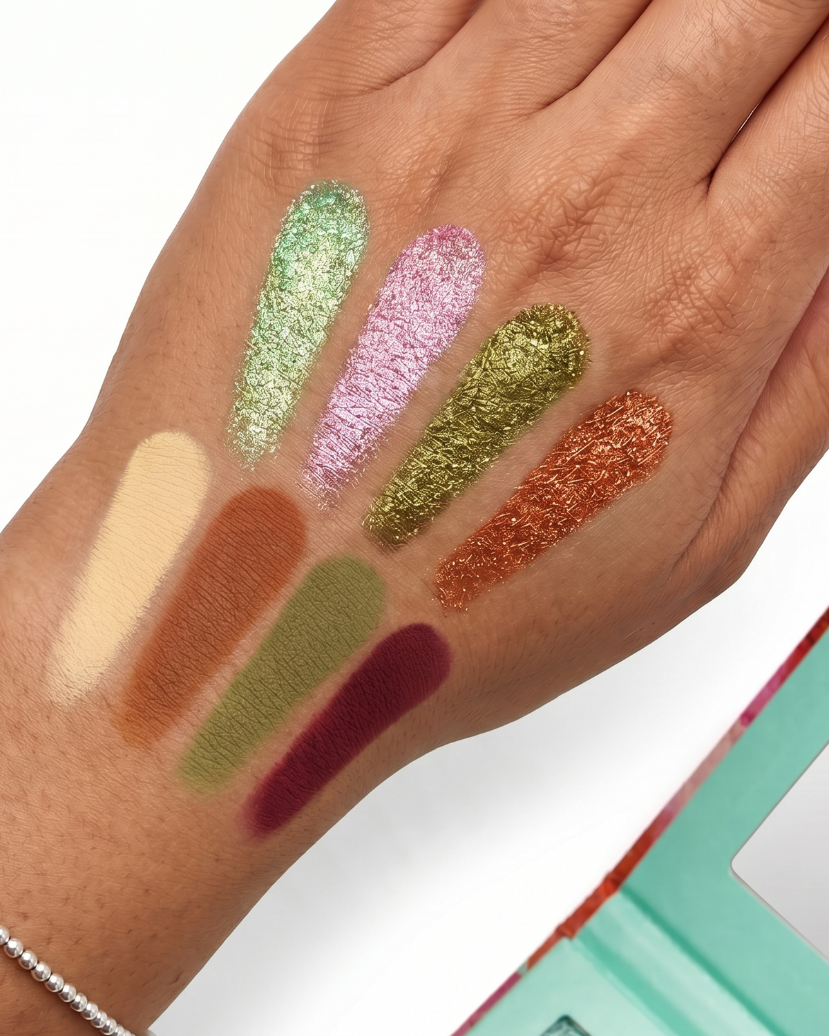 ALAMAR COSMETICS Princesa Del Caribe palette shade swatches on arm